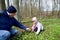 The grandfather gives to the granddaughter a flower of an wood anemone. Spring wood