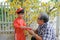 Grandfather giving lucky money to grandson on the first day of Vietnamese lunar new year Tet