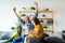 Grandfather and grandchild are smiling while playing with toys together at home