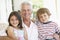 Grandfather With Grandchildren At Home