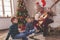 Grandfather and grandchildren playing the guitar and singing Christmas songs