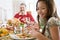 Grandfather And Granddaughter Sitting For Dinner