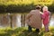 Grandfather with granddaughter in wood in autumn l