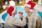 Grandfather and grandmother on christmas in Santa hats celebrate holiday