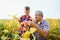 Grandfather and grandson check harvest of soy. People,farming, and agriculture concept