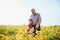 Grandfather and grandson check harvest of soy. People,farming, and agriculture concept