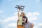 Grandfather and grandson enjoying play with plane together on blue sky. Cute child with granddad playing outdoor.