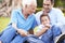 Grandfather With Grandson And Father In Park