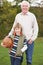 Grandfather With Grandson Holding Football