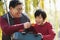 Grandfather and grandson looking at fishing tackle box