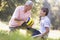 Grandfather and grandson at a park with a ball