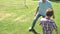 Grandfather And Grandson Playing Football In Garden At Home