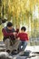 Grandfather and grandson putting lure on fishing line