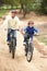 Grandfather and grandson riding bicycle in park