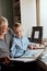 Grandfather and grandson on sofa at home. Grandpa and children watching old photos