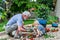 Grandfather and Grandson Spend Time Together Planting Flowers in the Garden