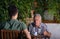 Grandfather and grandson talking in garden