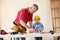 Grandfather and grandson working with wood in a garage