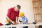 Grandfather and grandson working with wood in a garage