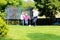 Grandfather and grandsons playing soccer in the garden