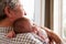 Grandfather Holding Sleeping Newborn Baby Granddaughter