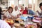 Grandfather making a toast standing at the dinner table celebrating with his family,close up