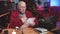 Grandfather on New Year writing christmas card sitting at table in cosy room