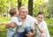 Grandfather playing with grandchildren. Boys hugging his grandfather