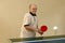 Grandfather playing ping pong