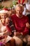 Grandfather With Present Of Socks As Multi-Generation Family Opening Gifts Around Christmas Tree