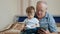 Grandfather Reading Book With Grandson