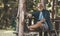 Grandfather is resting in an open gazebo in nature in the forest