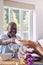 Grandfather Serving Food At Multi-Generation Family Meal At Home