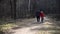 Grandfather shows a child, granddaughter how to ride a bike in a mountain forest park, forest trail