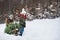 Grandfather and small girl getting a Christmas tree in forest. Copy space.