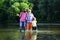 Grandfather with son and grandson having fun in river. Happy fathers day. Grandson with father and grandfather fishing