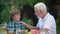 Grandfather talking to grandson, warm family relations, generation bridge