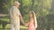 Grandfather talking to his granddaughter in the park.