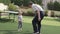 Grandfather teaches little granddaughter to play table tennis.