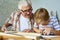 Grandfather Teaching Boy Carpentry