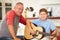 Grandfather Teaching Grandson To Play Guitar