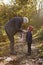 Grandfather Tying Granddaughter`s Scarf On Autumn Walk