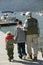 Grandfather Walking With Grandsons On Pier