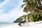 Grandfather In Wheelchair With Granddaughter At Beach