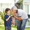 Grandfather whispering wish in ear of grandson