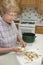 Grandma Cooking in her Kitchen, Peeling Potatoes