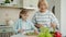 Grandma and cute child cooking salad for lunch talking making healthy meal at home