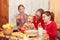 Grandma and granddaughters at  festive table in honor of Maslenitsa