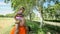 Grandma and grandfather carrying grand daughter on shoulders in nature in summer