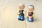 Grandma and grandpa dolls in chinese uniform style standing on wooden background. in chinese new year